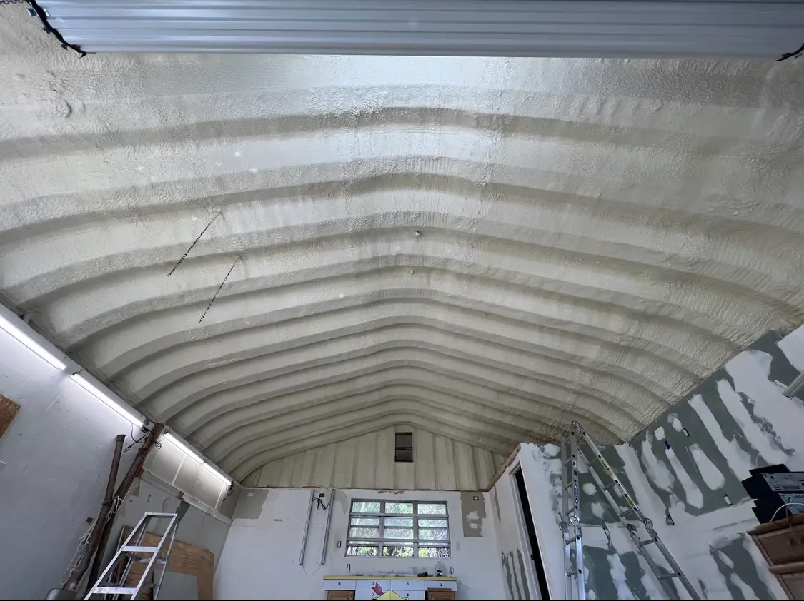 Spray polyurethane foam applied to the underside of a metal roof deck in Winterset